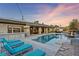Luxury pool, spa, and lounge area with outdoor kitchen at 8075 Palm Cove Ct, Las Vegas, NV 89129