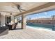 Large pool and patio area with seating and a dining set at 8075 Palm Cove Ct, Las Vegas, NV 89129