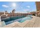 Inviting pool area with stylish patio, BBQ island, and ample lounge seating at 8075 Palm Cove Ct, Las Vegas, NV 89129