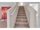 Modern staircase with wood steps and a white railing at 852 Sistine St, Las Vegas, NV 89144