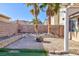 Backyard with fire pit, artificial turf, and mature palm trees at 9613 Sterling Ridge Ave, Las Vegas, NV 89129