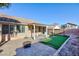 Backyard with covered patio, artificial turf, fire pit, and basketball hoop at 9613 Sterling Ridge Ave, Las Vegas, NV 89129