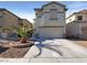 Two-story house with attached garage and desert landscaping at 9801 Fast Elk St, Las Vegas, NV 89143