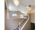 Elegant staircase with chandelier and wood-look floors at 9801 Fast Elk St, Las Vegas, NV 89143