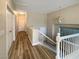 Upstairs hallway with wood-look floors and white railing at 9801 Fast Elk St, Las Vegas, NV 89143