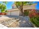 Two-story house with a three-car garage and nicely landscaped front yard at 1033 Logan Patrick Dr, Henderson, NV 89052