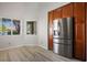 Kitchen with stainless steel refrigerator and light wood cabinets at 1033 Logan Patrick Dr, Henderson, NV 89052