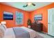 Brightly colored bedroom with a double bed and an eye-catching accent wall with decor at 10997 Sardinia Sands Dr, Las Vegas, NV 89141