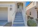 Inviting front entrance with stairs and white railings leading to the front door of this charming home at 10997 Sardinia Sands Dr, Las Vegas, NV 89141
