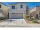 Charming two-story home featuring a two-car garage, landscaped front yard, and inviting curb appeal at 10997 Sardinia Sands Dr, Las Vegas, NV 89141