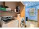 Laundry room featuring a washer and dryer with a colorful decorated adjoining room at 10997 Sardinia Sands Dr, Las Vegas, NV 89141