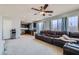 Open concept living room with a leather couch that flows into the kitchen at 10997 Sardinia Sands Dr, Las Vegas, NV 89141