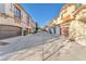 View of townhouses with attached garages and paved driveway at 1172 Via Ponte, Henderson, NV 89052