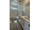 Well-lit bathroom featuring double sinks, vanity, a bathtub, and wood-look flooring at 1433 Nocturnal Flight St, Las Vegas, NV 89138