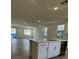 Open concept kitchen with an island, stainless steel dishwasher, and wood-look flooring at 1433 Nocturnal Flight St, Las Vegas, NV 89138