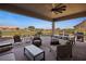 Covered patio with comfortable seating and views of the golf course at 1461 Sunshine Ct, Mesquite, NV 89034