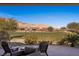 Peaceful backyard patio with seating and scenic golf course views at 1461 Sunshine Ct, Mesquite, NV 89034