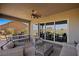 Outdoor patio with seating, dining areas and sliding glass doors at 1461 Sunshine Ct, Mesquite, NV 89034