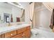 Clean bathroom with tub, toilet, and wood vanity at 1540 Castle Crest Dr, Las Vegas, NV 89117