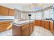 Island kitchen with wood cabinets and tile countertops at 1540 Castle Crest Dr, Las Vegas, NV 89117