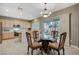 Bright dining area adjacent to the kitchen with a glass table and views to the backyard at 2009 Fern Hill Ct, Henderson, NV 89052