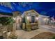 Night view of home's exterior, showcasing a well-lit walkway and landscaping at 2009 Fern Hill Ct, Henderson, NV 89052