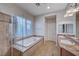 Elegant bathroom with soaking tub, double vanity, and glass shower at 2428 Granada Bluff Ct, Las Vegas, NV 89135