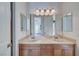 Well-appointed bathroom with double vanity and a view to the bedroom at 2428 Granada Bluff Ct, Las Vegas, NV 89135