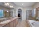 Large bathroom with dual sinks, a soaking tub, and a separate shower at 2428 Granada Bluff Ct, Las Vegas, NV 89135