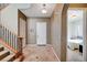 Bright entryway with tile flooring, staircase, and view to bedroom at 2428 Granada Bluff Ct, Las Vegas, NV 89135