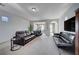 Bright Gathering room showcasing comfortable leather sofas and a home office at 2428 Granada Bluff Ct, Las Vegas, NV 89135