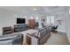 Gathering room with leather sofas, a large TV, and a built-in cabinet at 2428 Granada Bluff Ct, Las Vegas, NV 89135