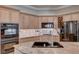 Modern kitchen with granite countertops and stainless steel appliances at 2428 Granada Bluff Ct, Las Vegas, NV 89135