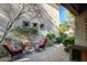 Private patio with seating, fountain, and landscaping at 2428 Granada Bluff Ct, Las Vegas, NV 89135