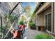 Small, brick patio with seating and landscaping at 2428 Granada Bluff Ct, Las Vegas, NV 89135