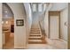 Elegant staircase with wrought iron railing and views to kitchen at 2428 Granada Bluff Ct, Las Vegas, NV 89135