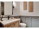 Stylish bathroom with modern vanity, gray wainscoting, and a frameless mirror at 358 E Torino Ave, Las Vegas, NV 89123