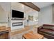 Living room with a cozy leather sectional and views into the kitchen at 358 E Torino Ave, Las Vegas, NV 89123