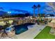 Resort-style pool and spa with waterfall feature; lush landscaping surrounds at 358 E Torino Ave, Las Vegas, NV 89123