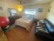 Bedroom with large bed, black couch, and ceiling fan at 4111 Sanderling Cir # 354, Las Vegas, NV 89103