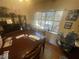 Bright dining area with wood table, window, and artwork at 4111 Sanderling Cir # 354, Las Vegas, NV 89103
