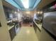 Galley kitchen with dark wood cabinets and appliances at 4111 Sanderling Cir # 354, Las Vegas, NV 89103
