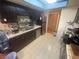 Dark wood kitchen cabinets, stainless steel appliances, and tile flooring at 4111 Sanderling Cir # 354, Las Vegas, NV 89103