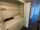 A dedicated laundry room with washer, dryer, and shelving for organizing laundry essentials at 4316 W Lake Mead Blvd # 102, Las Vegas, NV 89108