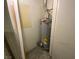 Enclosed water heater with energy guide and metal piping connections in a small storage area at 4316 W Lake Mead Blvd # 102, Las Vegas, NV 89108