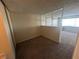 Hallway with carpet and a partial view of the living room and bedroom at 4600 University Center Dr # 95, Las Vegas, NV 89119