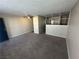 Living room with partial kitchen view, carpeted floor, and entryway at 4600 University Center Dr # 95, Las Vegas, NV 89119