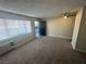 Living room with carpeted floor, window, and door leading to outside at 4600 University Center Dr # 95, Las Vegas, NV 89119