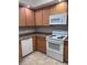 Well-equipped kitchen, wood cabinets, tile floor at 6160 Rumrill St # 113, Las Vegas, NV 89113