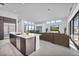 Bright, open living room featuring a modern kitchen island, clerestory windows, and a comfortable seating area at 623 Dragon Mountain Ct, Henderson, NV 89012